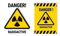 Yellow signs with triangle and text saying Danger Radioactive.