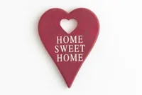 A red heart-shaped plaque with the words "Home Sweet Home".