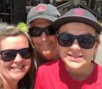 A family of three is posing for a photo.