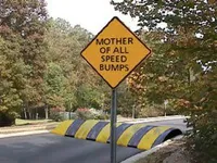 Warning sign for large speed bumps ahead.